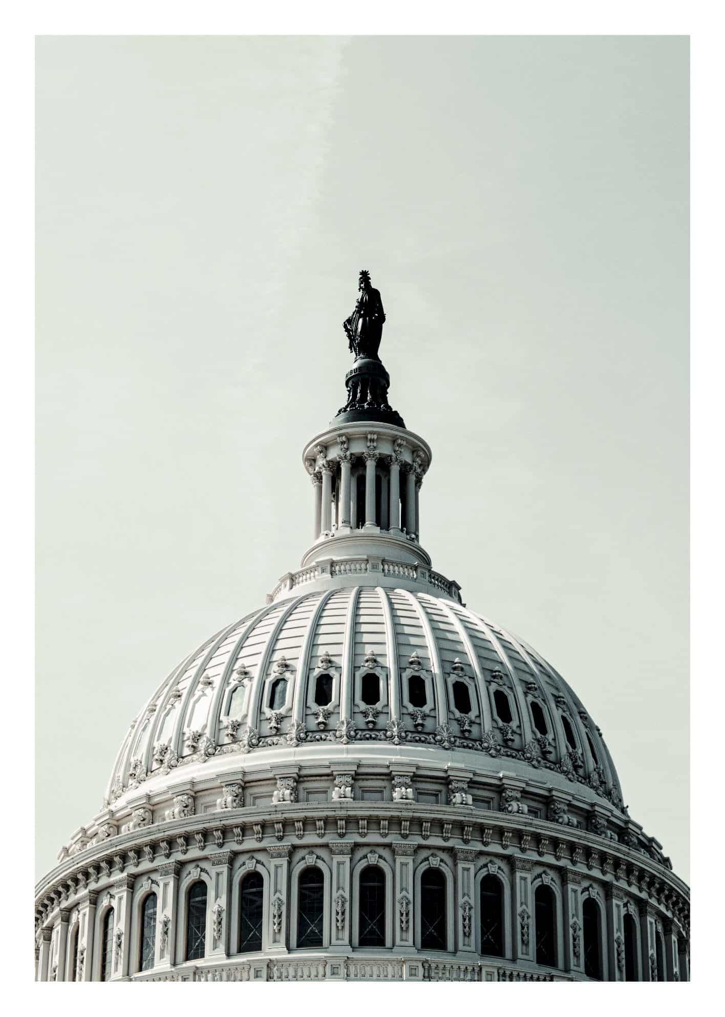 White building with stone statue poster