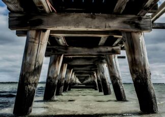 View underneath of a long jetty in Australia poster